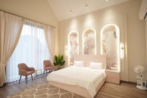 a bedroom with a white bed and a table and chairs at Sukoon Luxury Stay in Amritsar