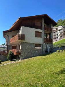 a house on a hill with a green field at Il Faggio Rosso Apartment in Vernante