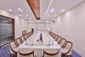 a conference room with a long table with chairs at Avari Boutique Multan in Multan