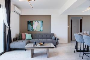 a living room with a couch and a table at Mayan 2-Bedroom Apartment in Larnaca