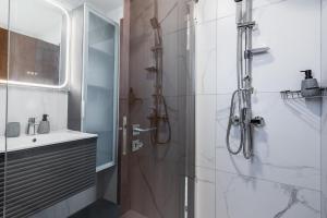 a bathroom with a shower and a sink at Mayan 2-Bedroom Apartment in Larnaca +11 photos
