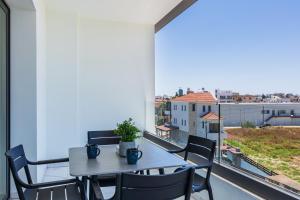 a table and chairs on a balcony with a view at Mayan 2-Bedroom Apartment in Larnaca