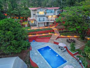 an aerial view of a house with a swimming pool at Table Land Retreat in Panchgani