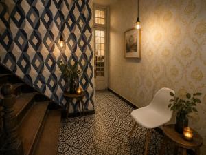 a stairway with a white chair in a room at Downtown Guest house in Santiago