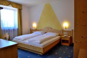 Postel nebo postele na pokoji v ubytování Hotel Urthaler