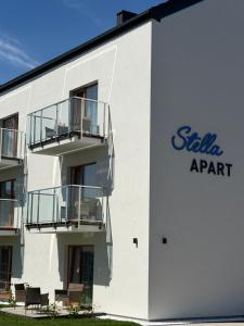 a white building with a sign on the side of it at Stella APART Resort & SPA in Władysławowo