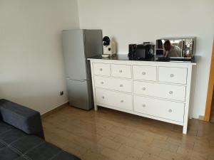 a room with a white dresser and a refrigerator at Westblick in Plön