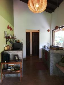 a kitchen with a counter and a table in a room at The Secret Guesthouse in Mirissa