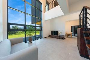 a living room with a couch and a tv at Goseung Poolhouse Poolvilla 151 in Goseong