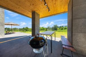 a room with a table and a helmet on a deck at Goseung Poolhouse Poolvilla 151 in Goseong