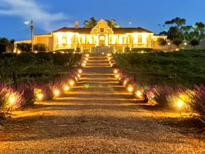 a pathway leading to a house at night with lights at Maison PJURE Boutique Hotel & Spa , Adults Only in Montagu
