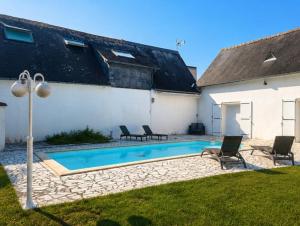 a swimming pool in the backyard of a house at Maison privée spacieuse avec piscine chauffée pour 8 personnes in Joué-lès-Tours