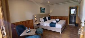 a hotel room with a bed and a table and chairs at Hunza Embassy Hotel by Zeez in Karimabad Hunza
