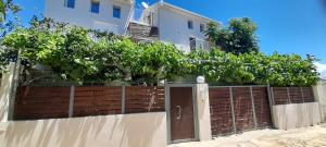 a fence with a wooden gate in front of a house at ERA Studios2 in Skiathos