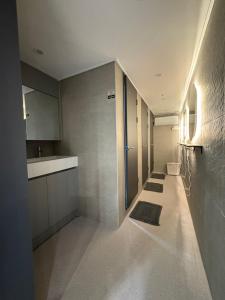 a hallway of a bathroom with two sinks and counters at Hostel K wave Only Female Hongdae in Seoul +52 photos