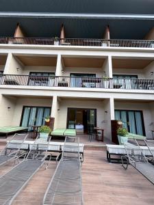 a building with chairs and tables in front of it at Simple Life Resort Koh Tao in Ko Tao