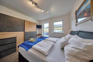 a bedroom with a large white bed in it at Apartment Alpenstyle Ennstal in Aich