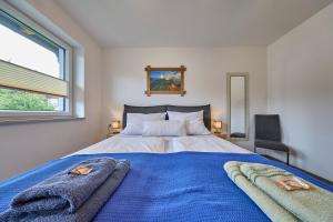 a bedroom with a bed with two towels on it at Apartment Alpenstyle Ennstal in Aich