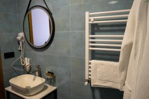 a bathroom with a sink and a mirror at Kazbegi Hotel Grand View in Kazbegi