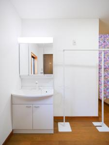 a white bathroom with a sink and a mirror at 雪の宿 in Numata +122 photos