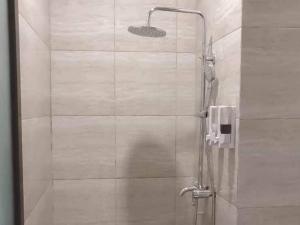 a shower with a glass door in a bathroom at Jatiwangi Syariah Guest House Mitra RedDoorz in Majalengka