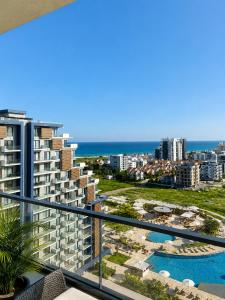 a view of the ocean from a balcony of a building at Rıversıdelıfe Iskele M 147 in Aglantzia