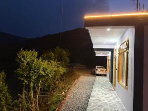 a car parked outside of a house at night at Pahadi Aangan Chakrata in Kailāna +60 photos
