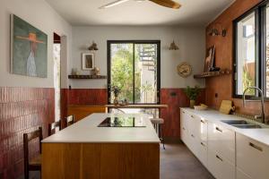 a kitchen with white cabinets and a large island at CASA FRIDA by DW in San Juan +46 photos