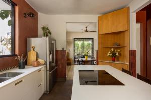 a kitchen with white counters and a refrigerator at CASA FRIDA by DW in San Juan