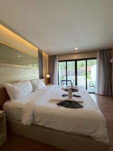 a bedroom with a large white bed with a large window at Simple Life Resort Koh Tao in Ko Tao +60 photos