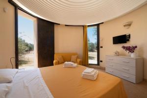 a bedroom with a large bed with a large window at Residenze Uliveto - Rooms in Nardò