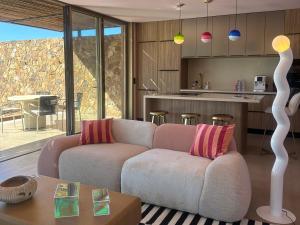 a living room with a couch and a kitchen at Alpa Nera in Galeria