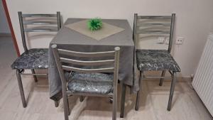a dining room table with two chairs and a plant on it at MARIOS HOUSE 1 in Xanthi