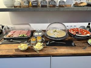a counter with many different types of food on it at Hotel Villa WUN in Wunsiedel +25 photos