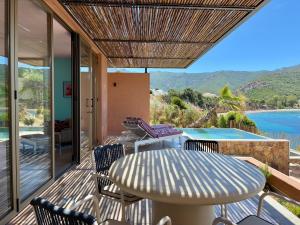 a patio with a table and chairs and a pool at Alpa Nera in Galeria