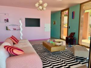 a living room with a couch and a tv at Alpa Nera in Galeria