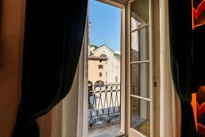 an open window with a view of a castle at Palazzo San Fedele - Como Suites in Como