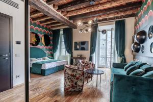 a hotel room with a bed and a couch at Palazzo San Fedele - Como Suites in Como