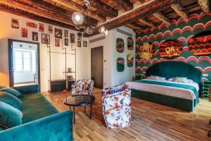 a hotel room with a bed and a couch at Palazzo San Fedele - Como Suites in Como