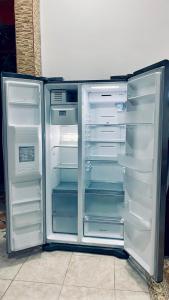 an empty refrigerator with its door open with its door open at Casa Largo Katayama in Ruiosucio