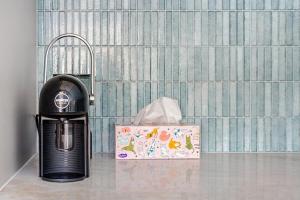 a black heater next to a box in a bathroom at Captain's Pick at Manly Beach plus Parking in Sydney