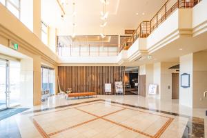 an empty lobby of a building with a staircase at Rembrandt Resort Shiretoko in Shari