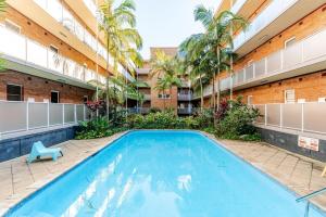 a swimming pool in the courtyard of a building at Captain's Pick at Manly Beach plus Parking in Sydney