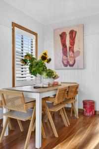 a dining room table with chairs and a vase of flowers at Styled Entertainer only mins from CBD in Bendigo +25 photos