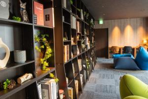 a library with book shelves with books at Rembrandt Resort Shiretoko in Shari