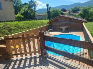 a fence around a swimming pool next to a house at Le Refuge De L'Ourse in Anla +32 photos