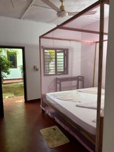 a bedroom with a canopy bed in a room at Lime pepper in Pottuvil