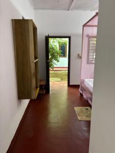 a room with a door open to a room with a bedroom at Lime pepper in Pottuvil