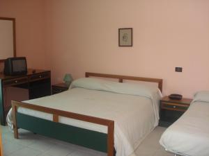 Ένα ή περισσότερα κρεβάτια σε δωμάτιο στο Hotel Grandinetti