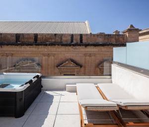 a hot tub on the roof of a building at The Republic Boutique Hotel in Valletta